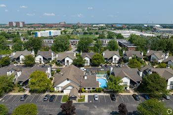 A large complex of houses with a pool in the middle